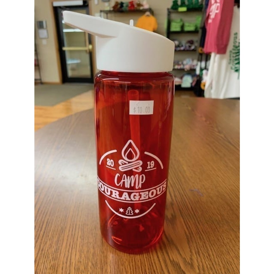 Red water bottle with white "Camp Courageous 2019" graphic